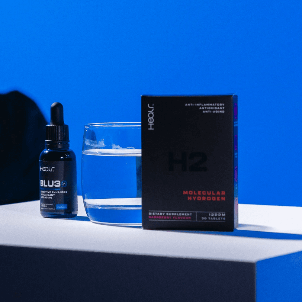 HEALR Blu3 30ml nootropic bottle next to a glass of water and H2 molecular hydrogen supplement box.